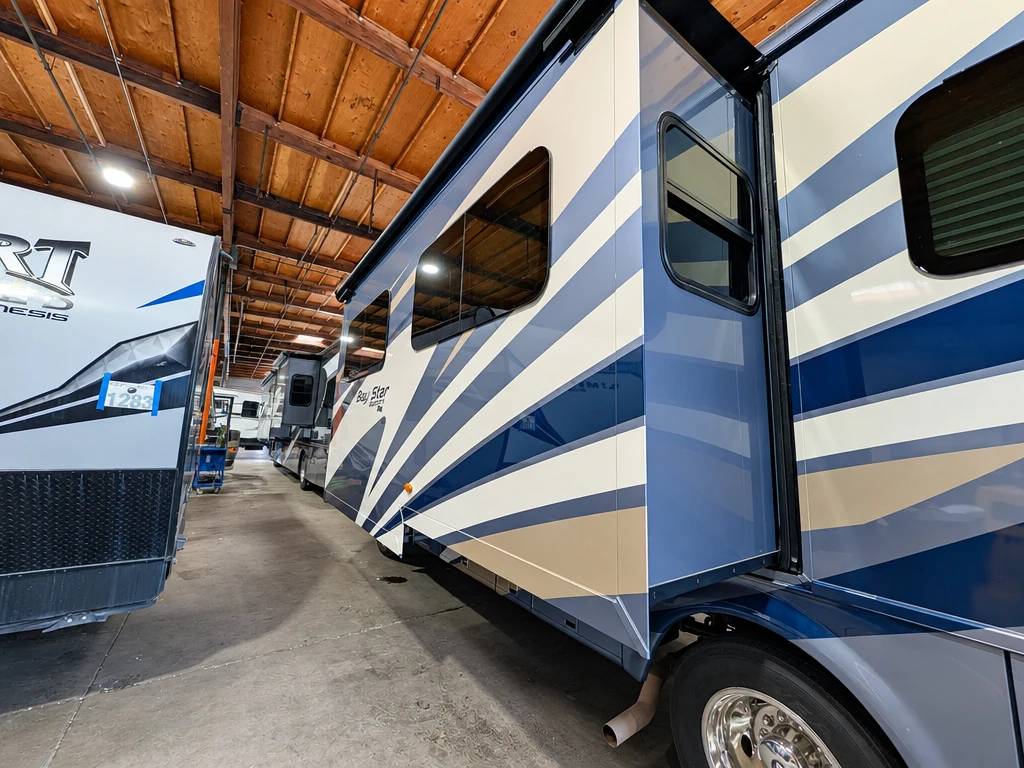 Slide-out and seals on a blue-striped Class A motorhome