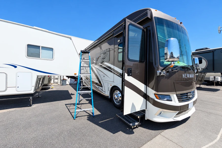 Class A motorhome with its entry door open outside El Toro RV Service