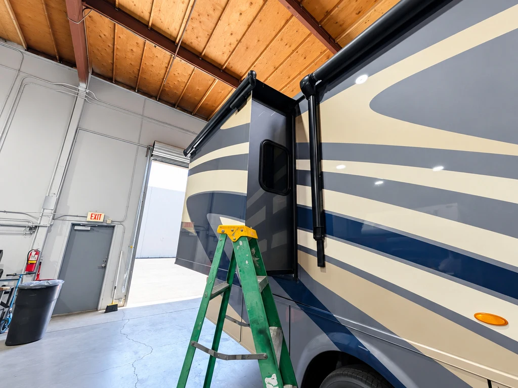 Ladder set at the slide-out of a Class A motorhome during slide seal service