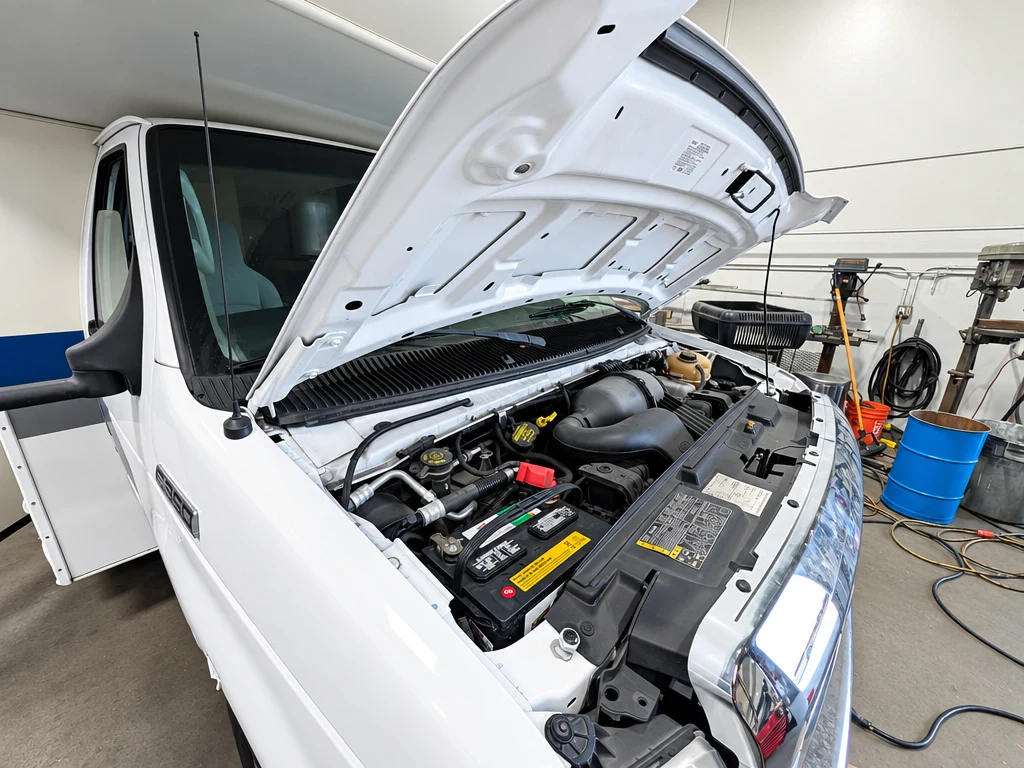 Ford E-Series Class C motorhome chassis with the hood open for service