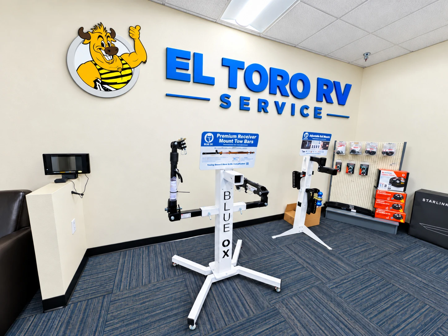 El Toro RV Service customer lobby with the bull logo wall and tow bar display
