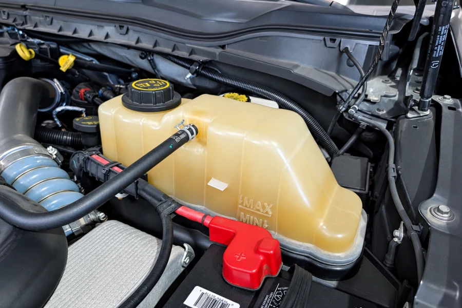 Close-up of an engine coolant reservoir checked during RV maintenance