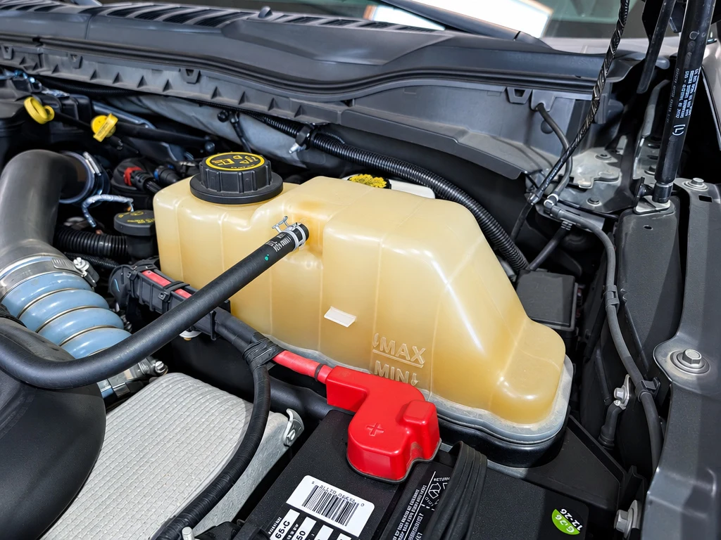 Close-up of an engine coolant reservoir checked during RV maintenance