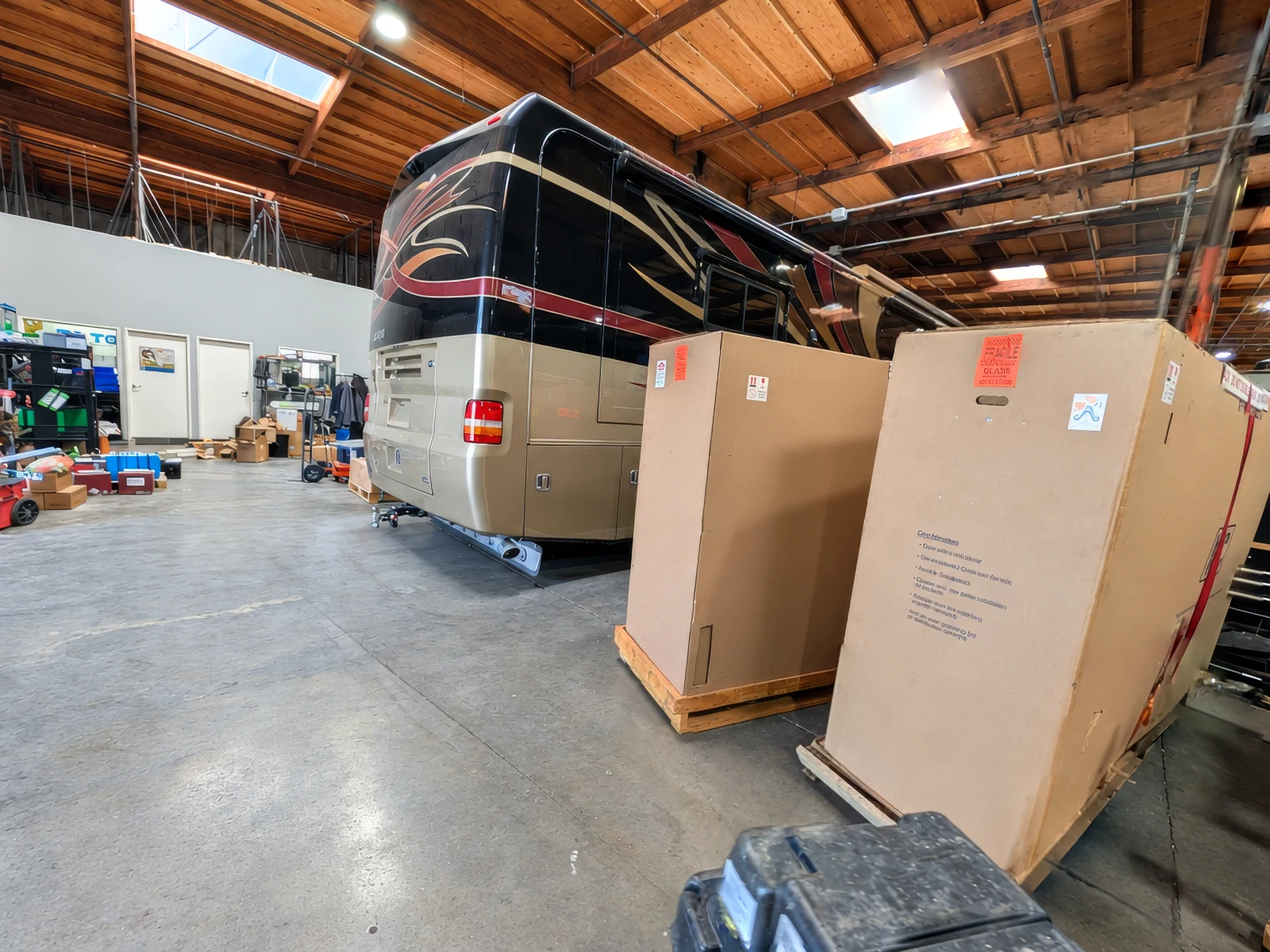 New parts boxes delivered beside a Class A diesel coach in service