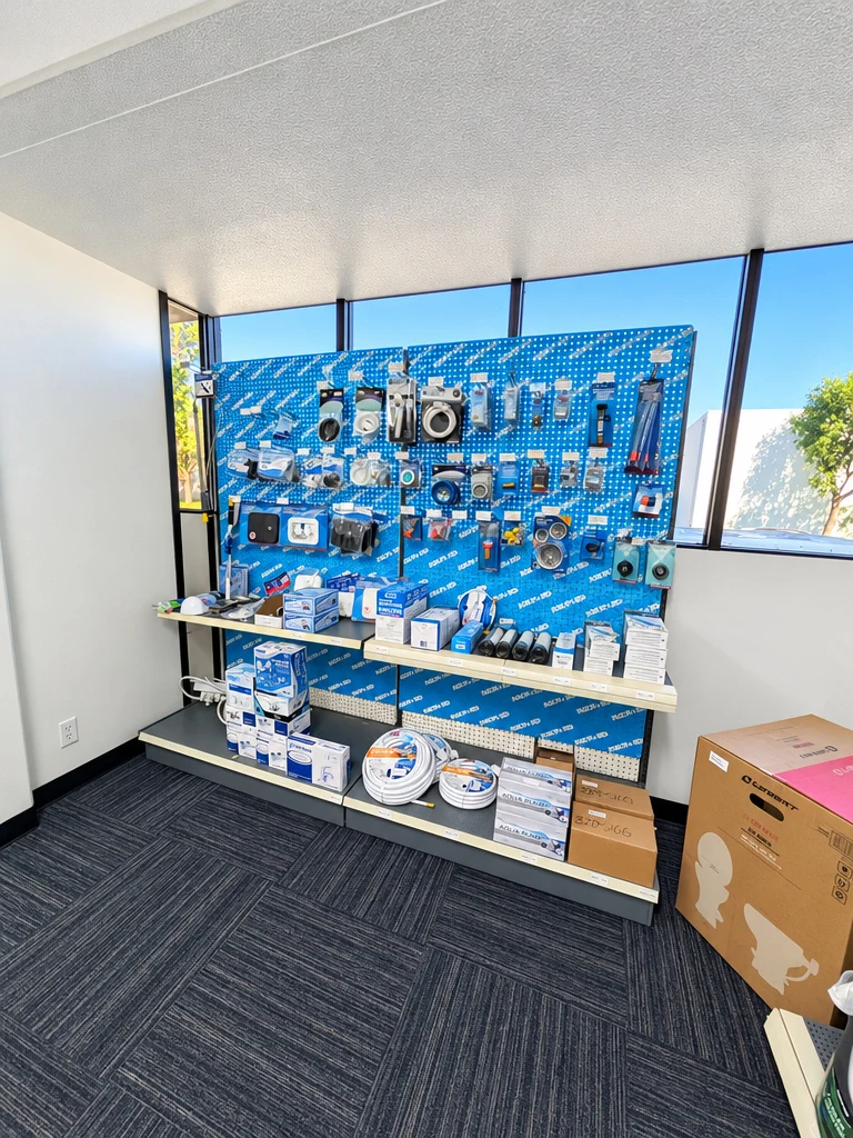 Window display of RV plumbing fittings and hardware at El Toro RV Service