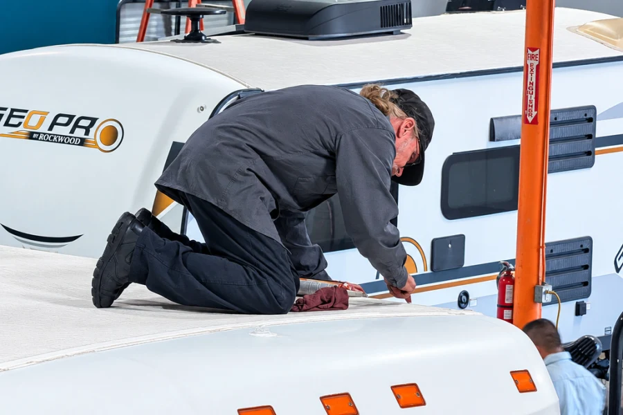 El Toro RV Service technician kneeling on an RV roof during a roof inspection in Orange, CA