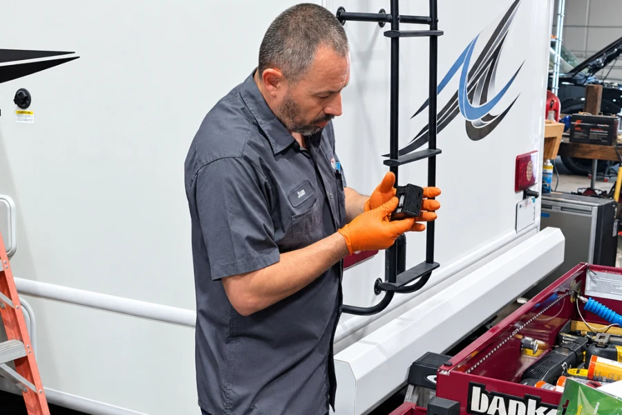 El Toro RV Service technician installing a rear ladder on a motorhome