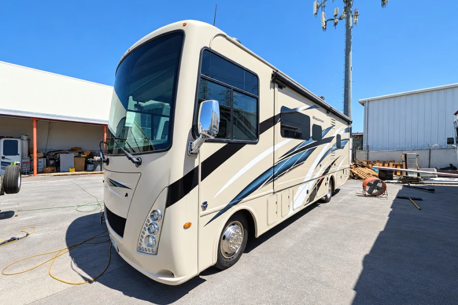 Cream Class A motorhome parked outside El Toro RV Service in Orange, CA