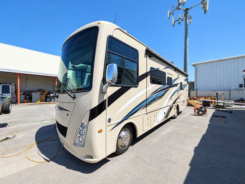 Cream Class A motorhome parked outside El Toro RV Service in Orange, CA