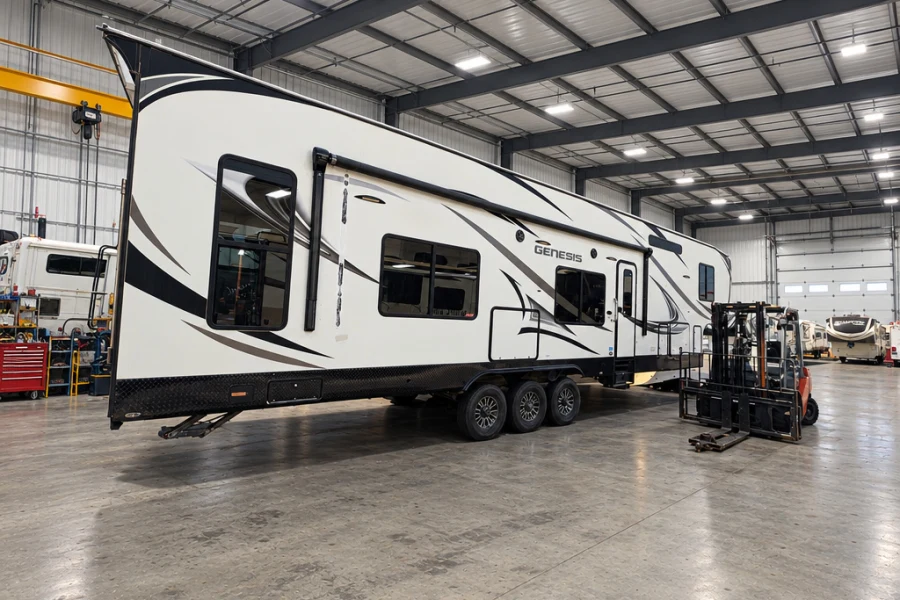 Toy hauler travel trailer moved into the El Toro RV Service bay with a forklift